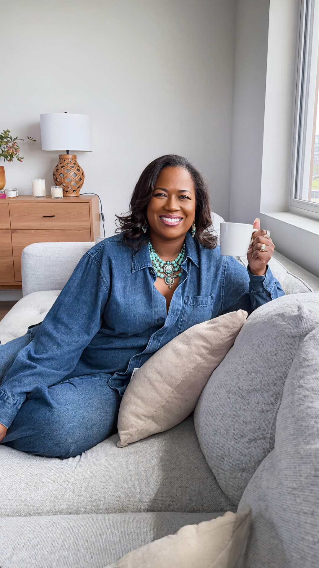 Arnitha Webb, founder of RYL Abroad, smiling with a coffee mug in her Spain home