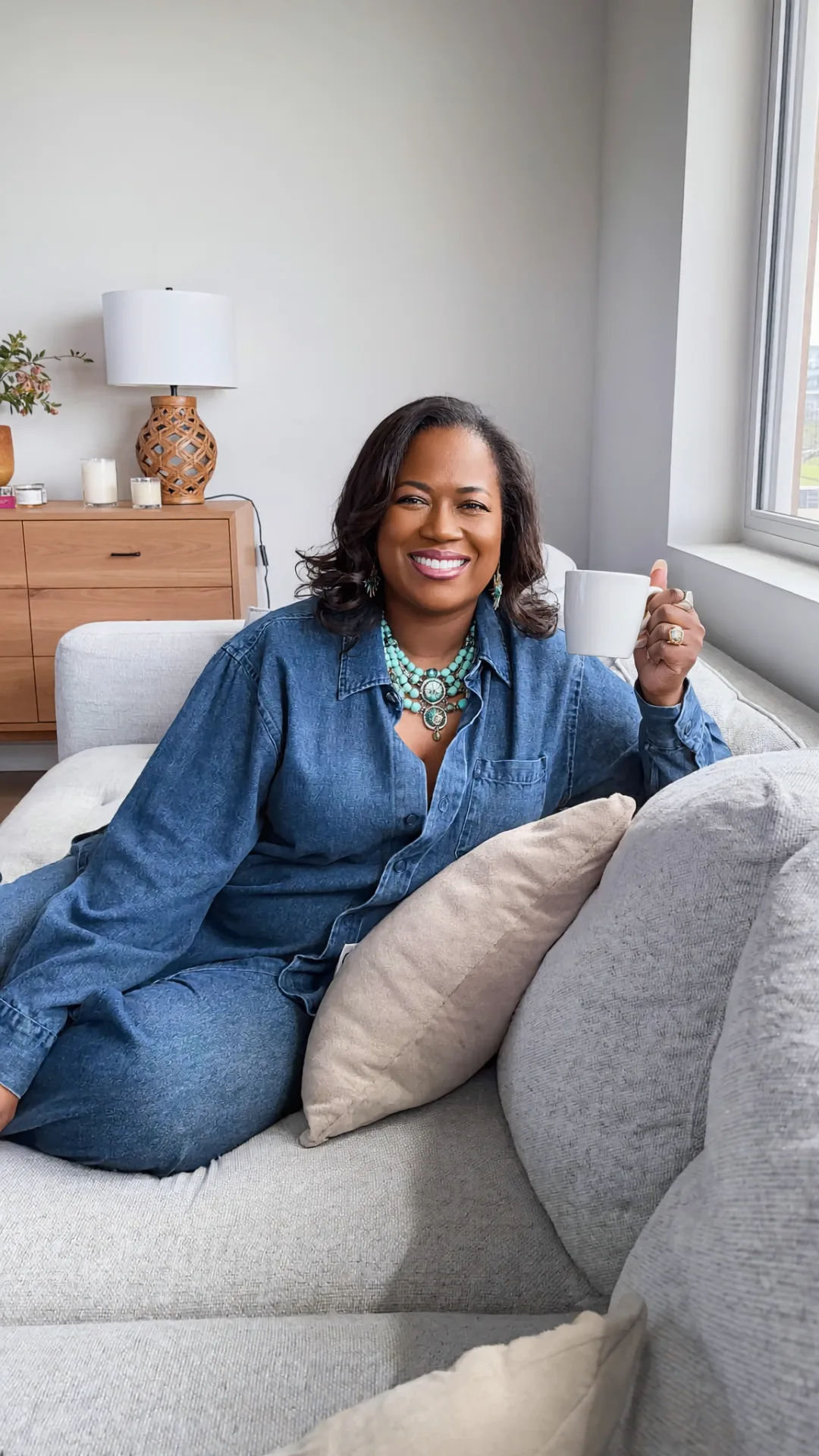 Arnitha Webb smiling with a coffee mug at home